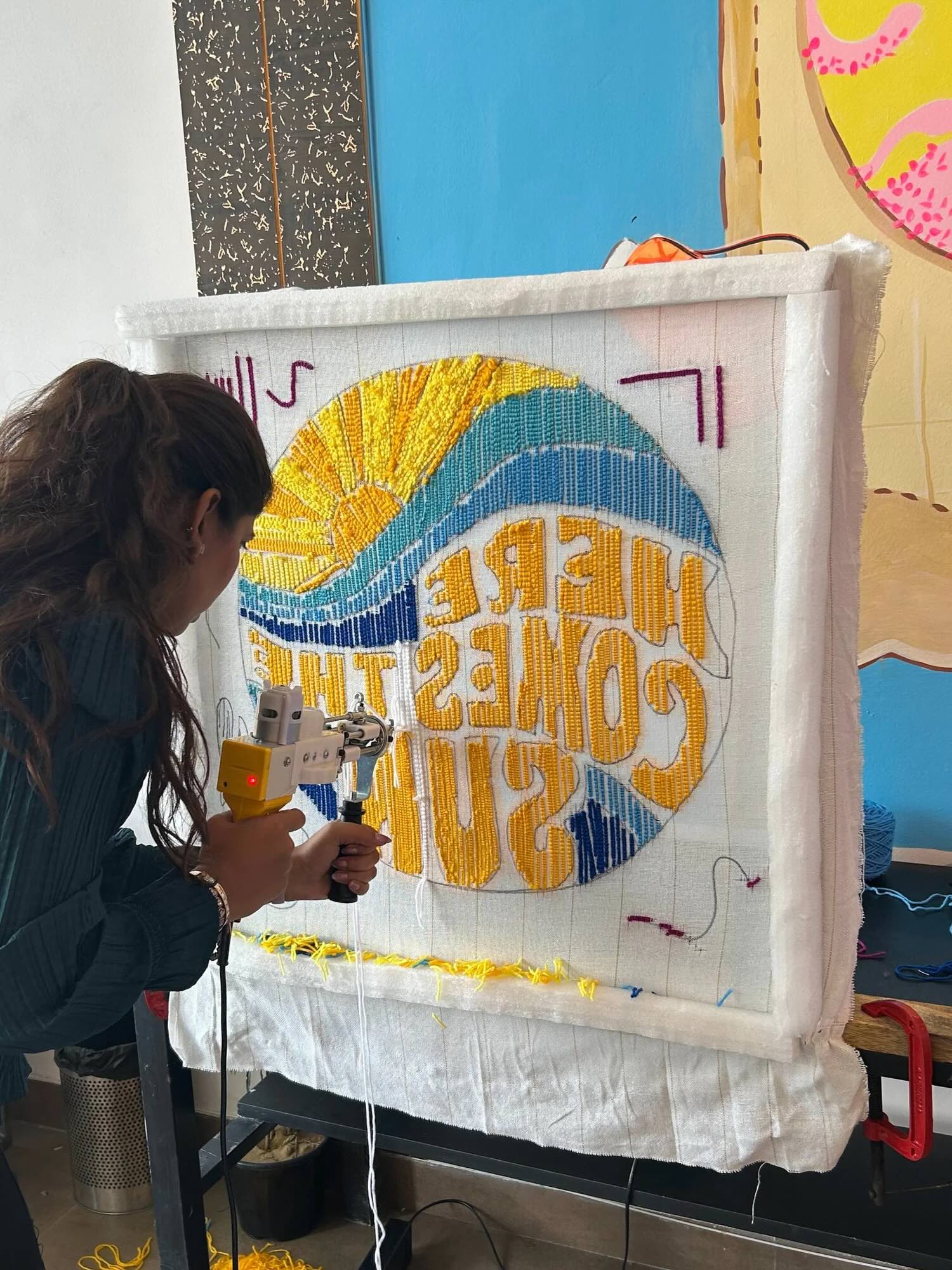 Participants tufting a custom rug at the workshop