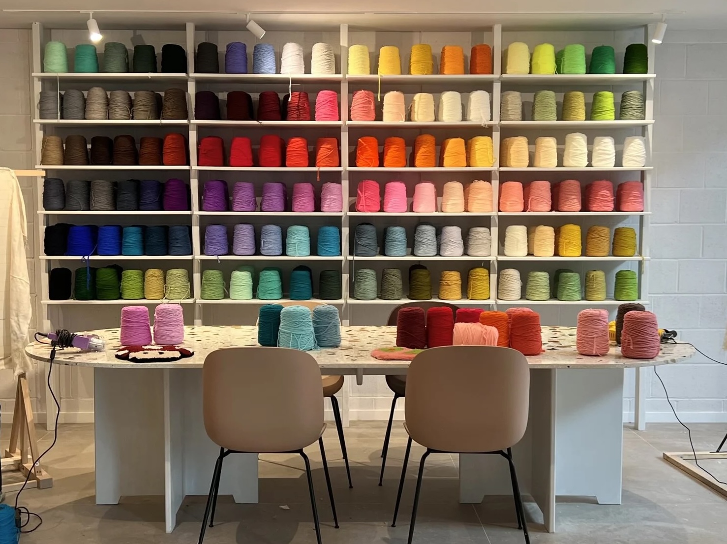 A colorful display of finished tufted rugs