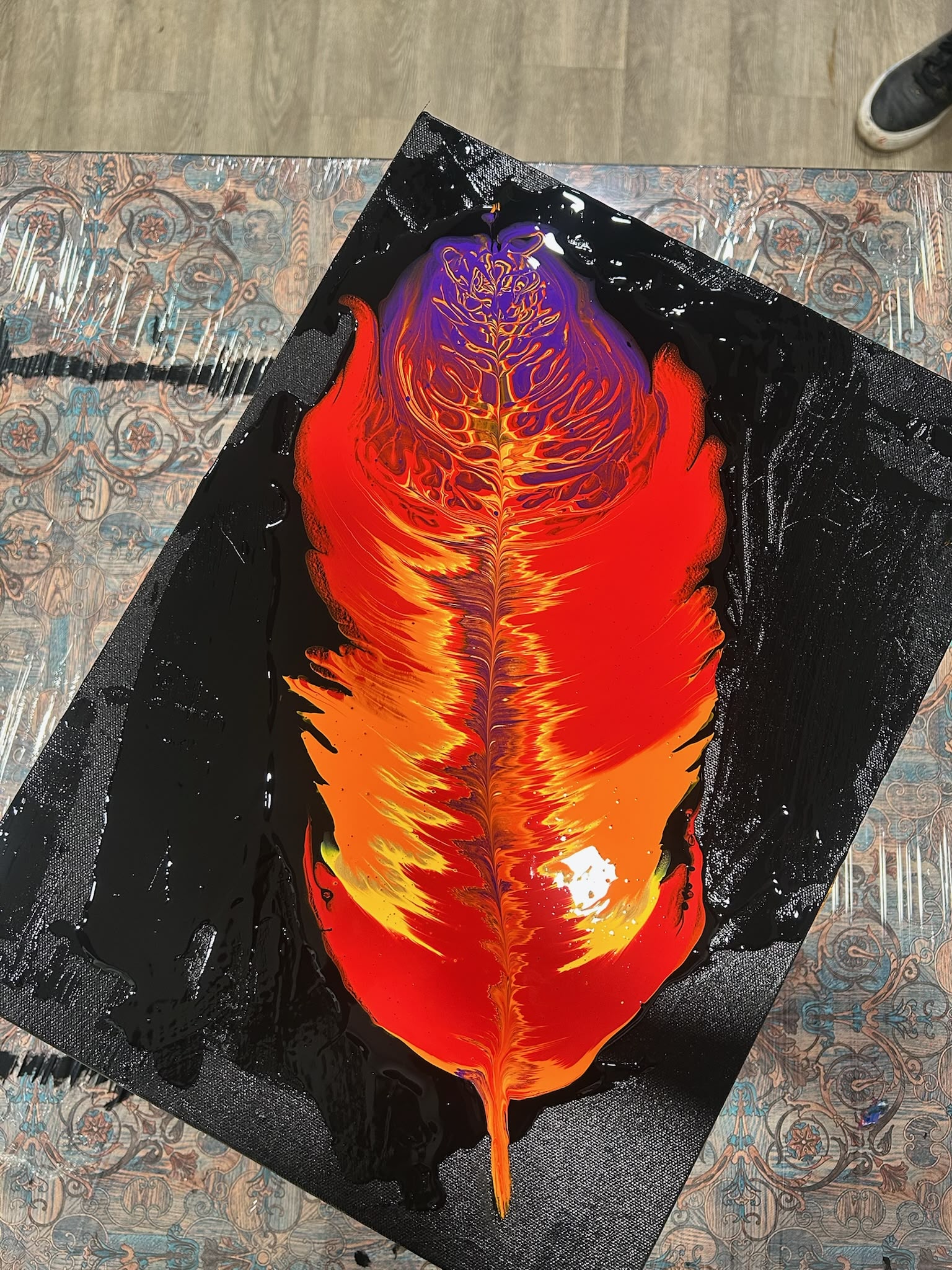 Woman creating colourful acrylic pour fluid art on canvas at Splashit