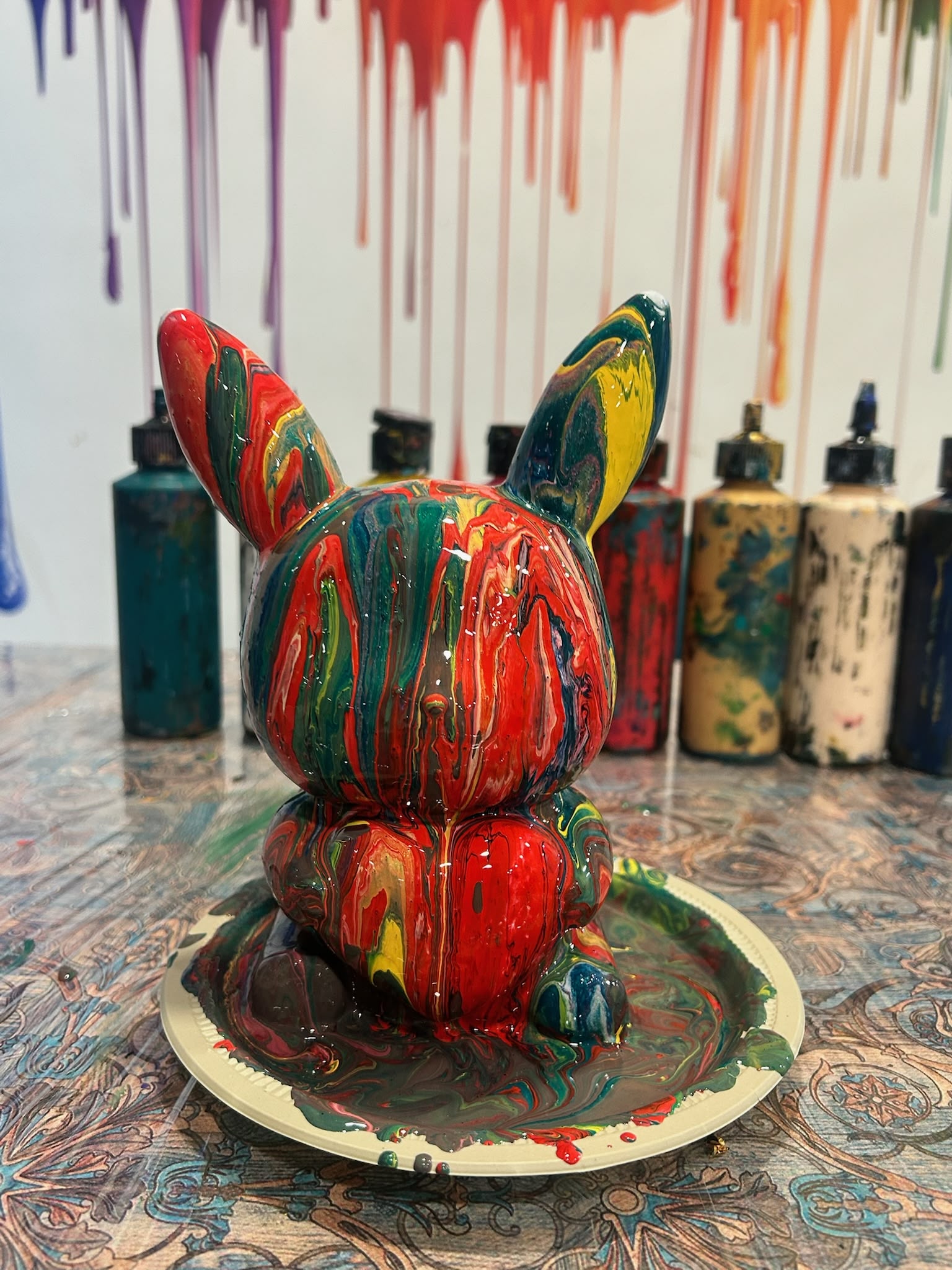 Colourful acrylic-poured plaster teddy bear made at Splashit